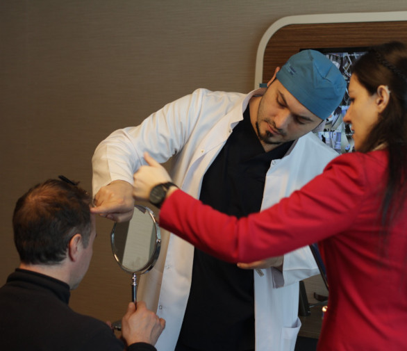 Dr Balwi analysing his patients hair before their hair transplant