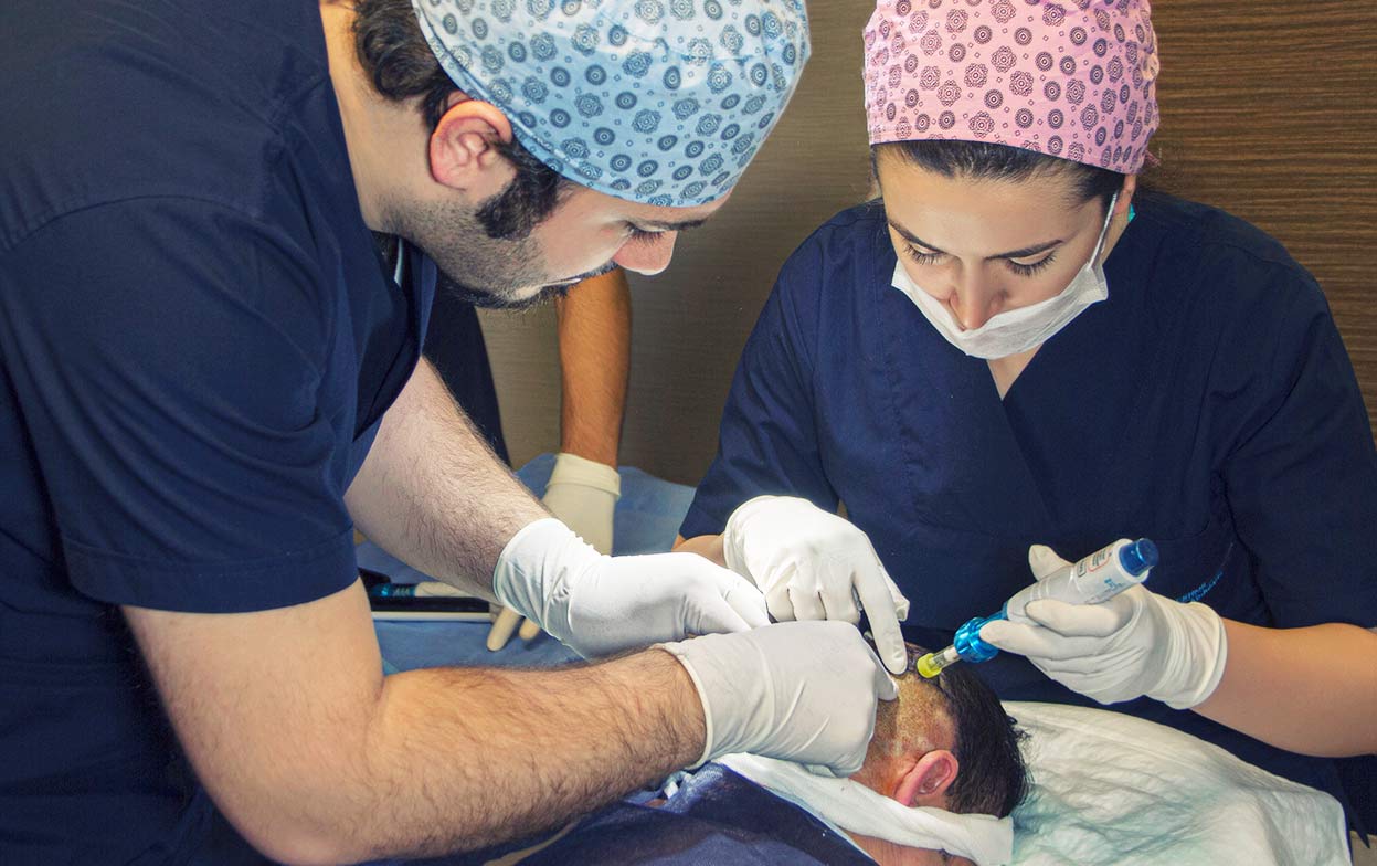 Dr. Balwi supervises the correct application of the Comfort-In needle-free anaesthesia on a patient.